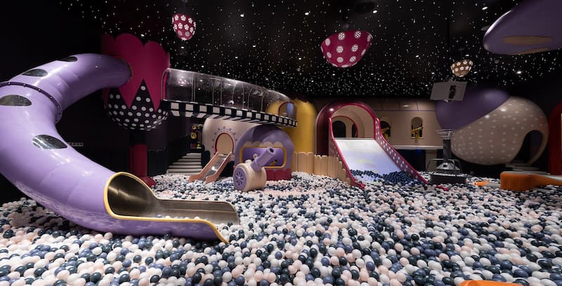 Multi-level indoor play structure with foam padding and themed décor